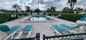 720 Joel Boulevard Lehigh Acres, FL 33936 - Photo 8 of 9 a view of swimming pool with outdoor seating and plants