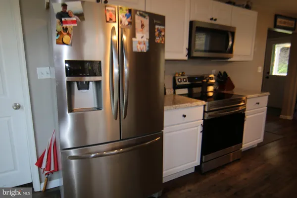 a kitchen with stainless steel appliances and refrigerator