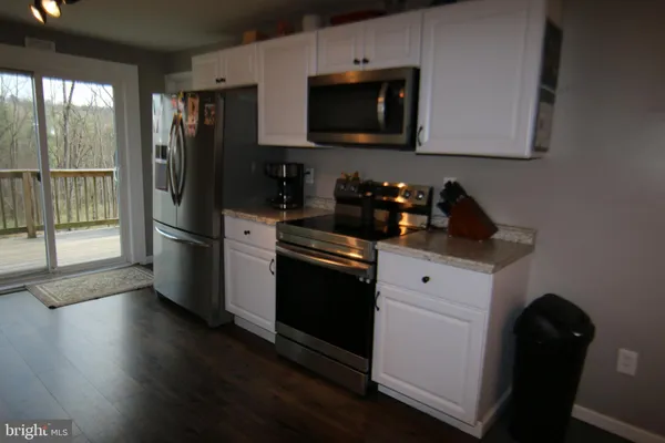 a kitchen with a sink stove and microwave