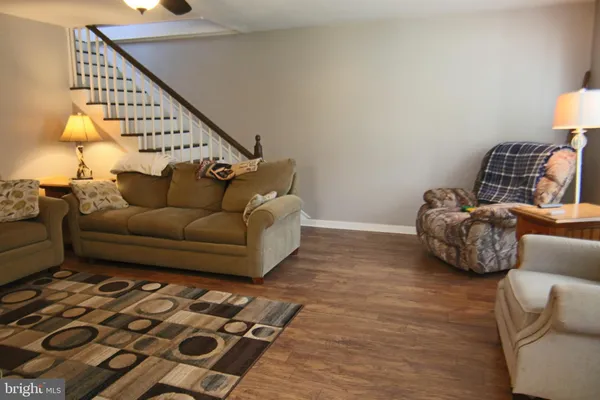 a living room with furniture and a lamp