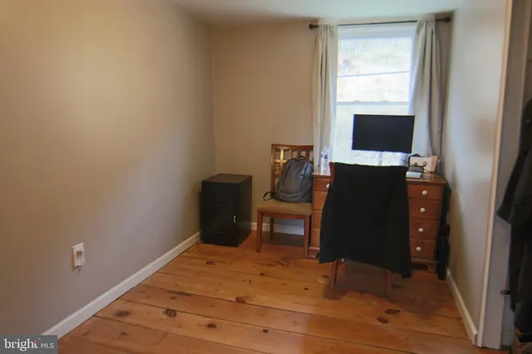 a bedroom with a bed and a television