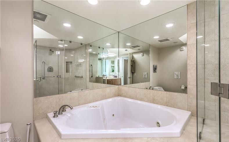 2777 Paradise Road, Unit 807 Las Vegas, NV 89109 - Photo 19 of 61 Indulge in a corner jetted tub and a glass-enclosed shower, creating a serene spa-like retreat.