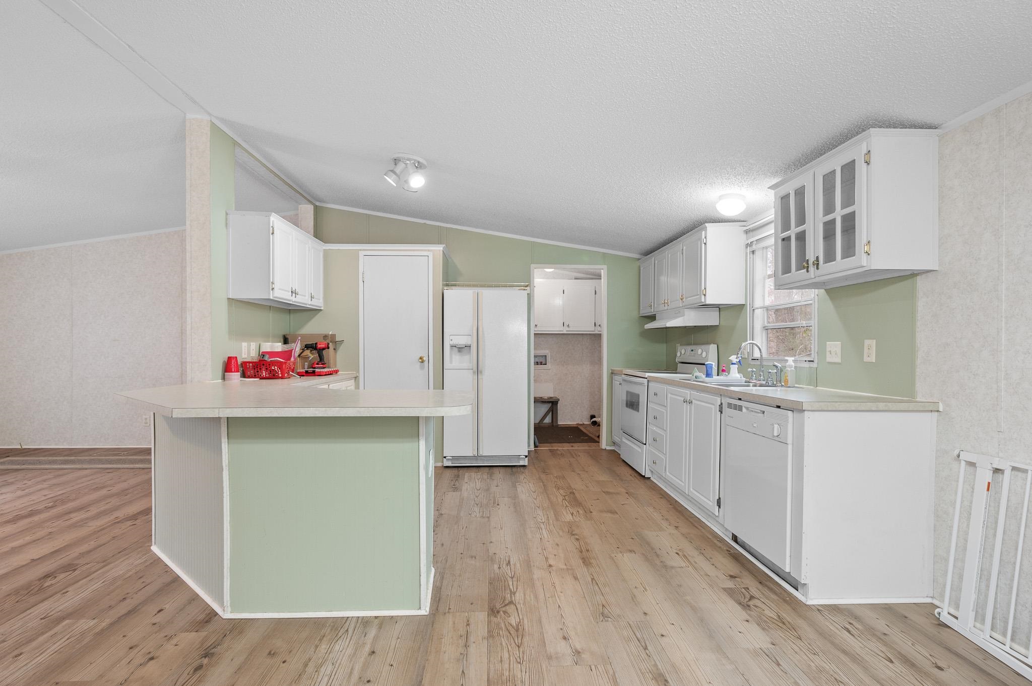 140 Garford Road Madison Heights, VA 24572 - Photo 11 of 32 a kitchen with granite countertop a refrigerator and a sink