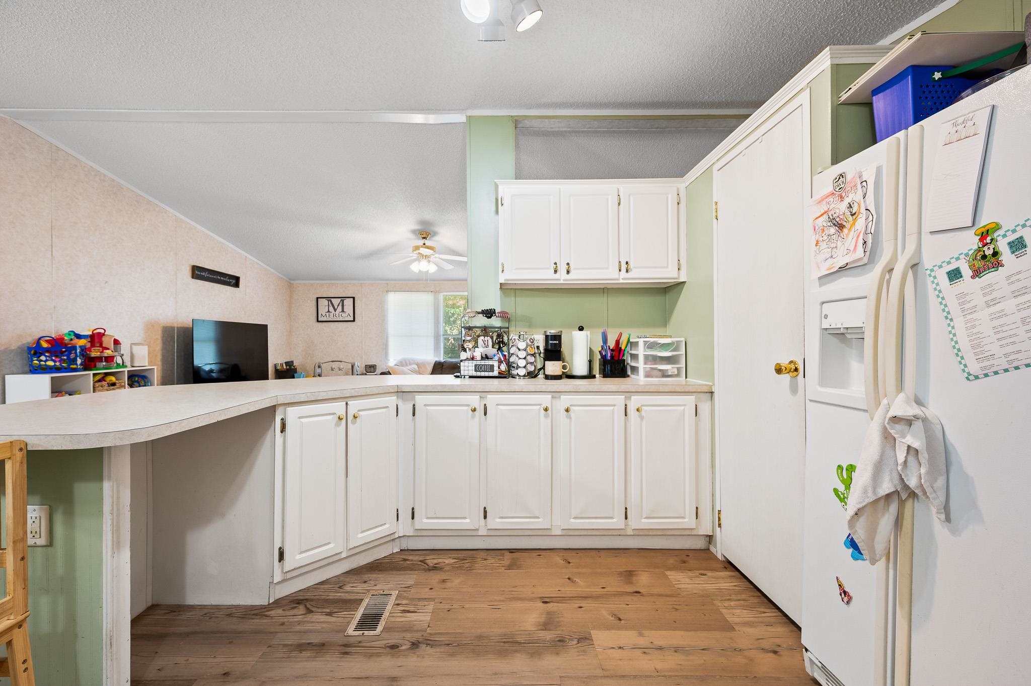 140 Garford Road Madison Heights, VA 24572 - Photo 13 of 35 a kitchen with white cabinets and refrigerator