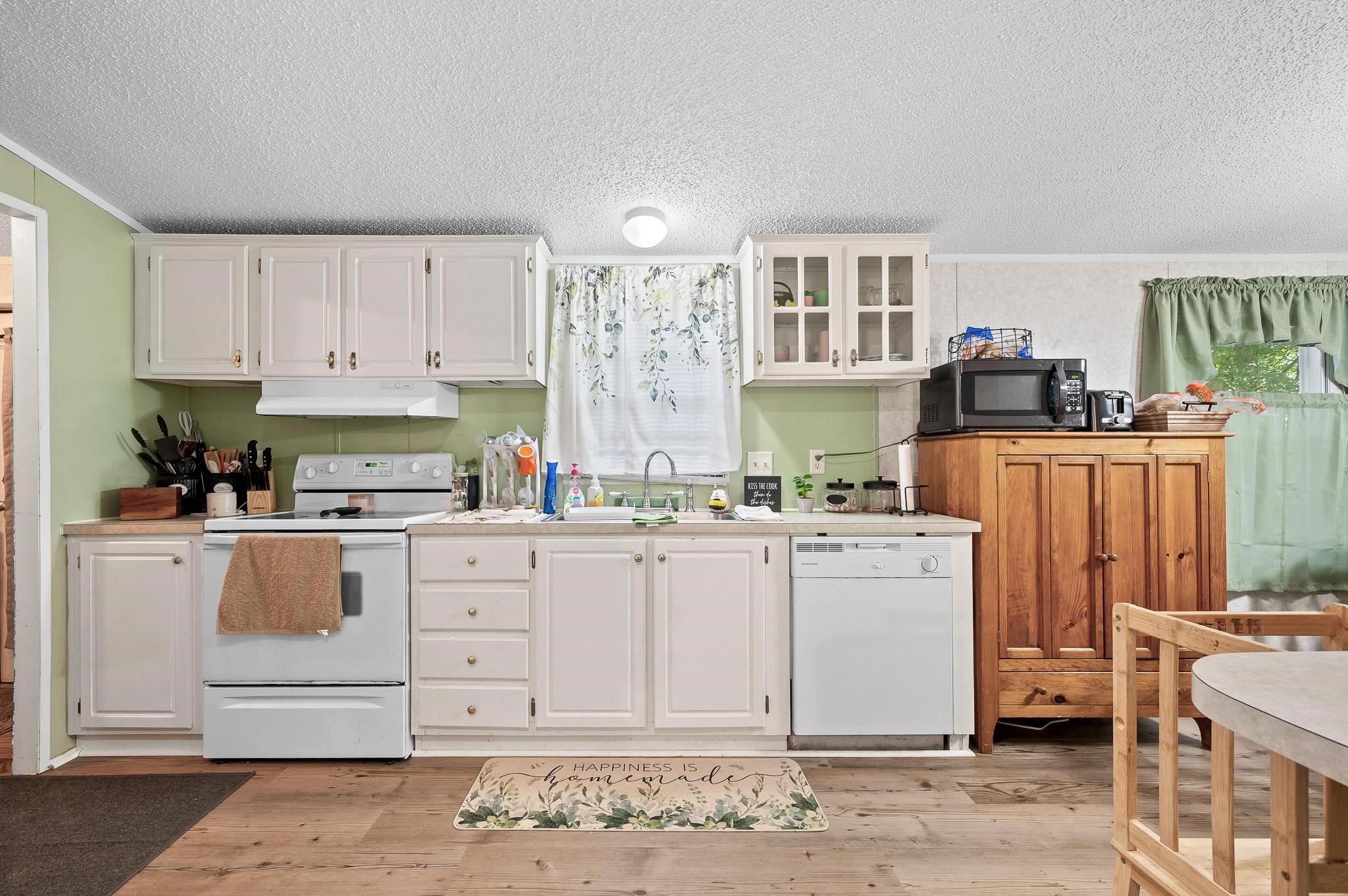 140 Garford Road Madison Heights, VA 24572 - Photo 14 of 35 a kitchen with cabinets and wooden floor