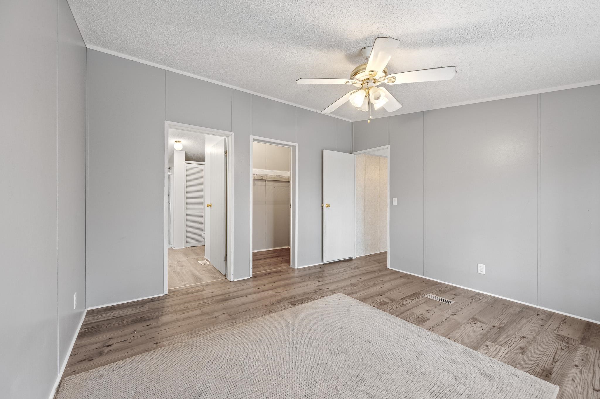 140 Garford Road Madison Heights, VA 24572 - Photo 15 of 32 wooden floor in an empty room with a fan