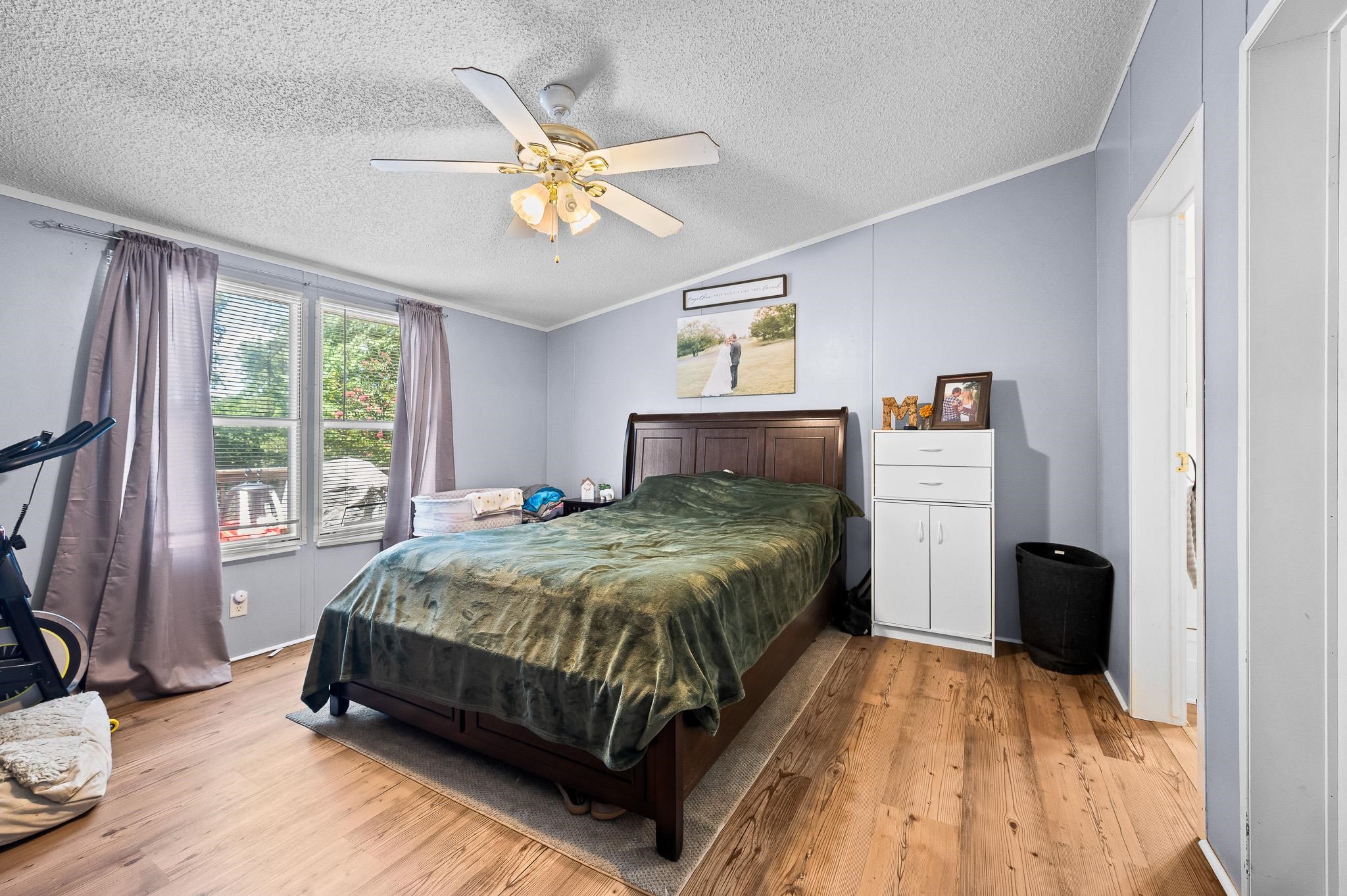 140 Garford Road Madison Heights, VA 24572 - Photo 16 of 35 a bedroom with a bed and a chandelier