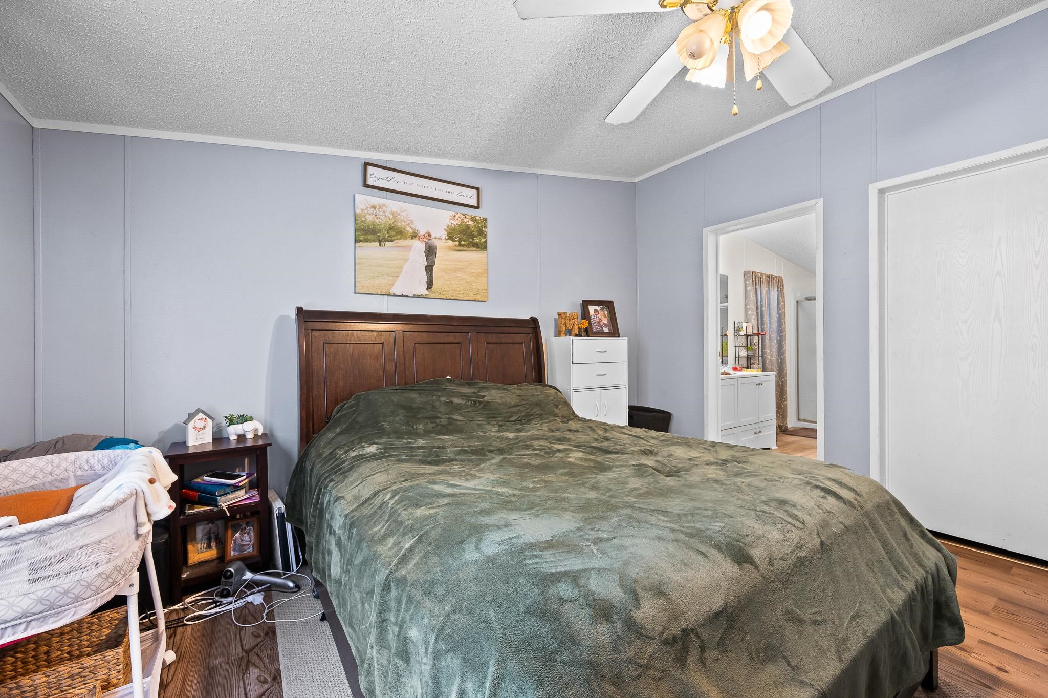 140 Garford Road Madison Heights, VA 24572 - Photo 17 of 35 a bedroom with a bed and a chandelier