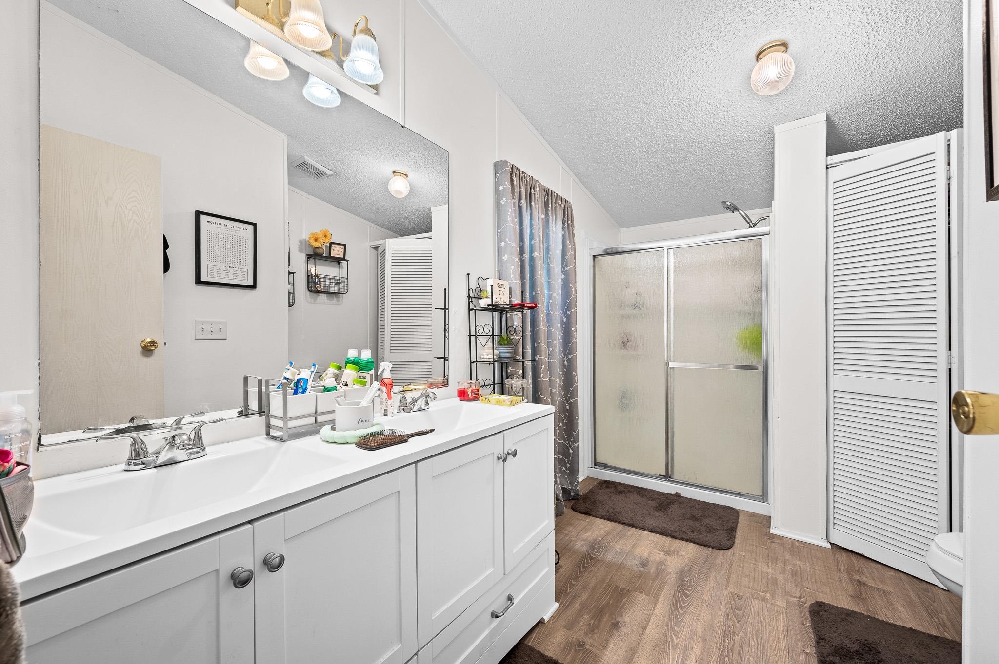 140 Garford Road Madison Heights, VA 24572 - Photo 18 of 35 a bathroom with a sink a mirror a vanity and shower