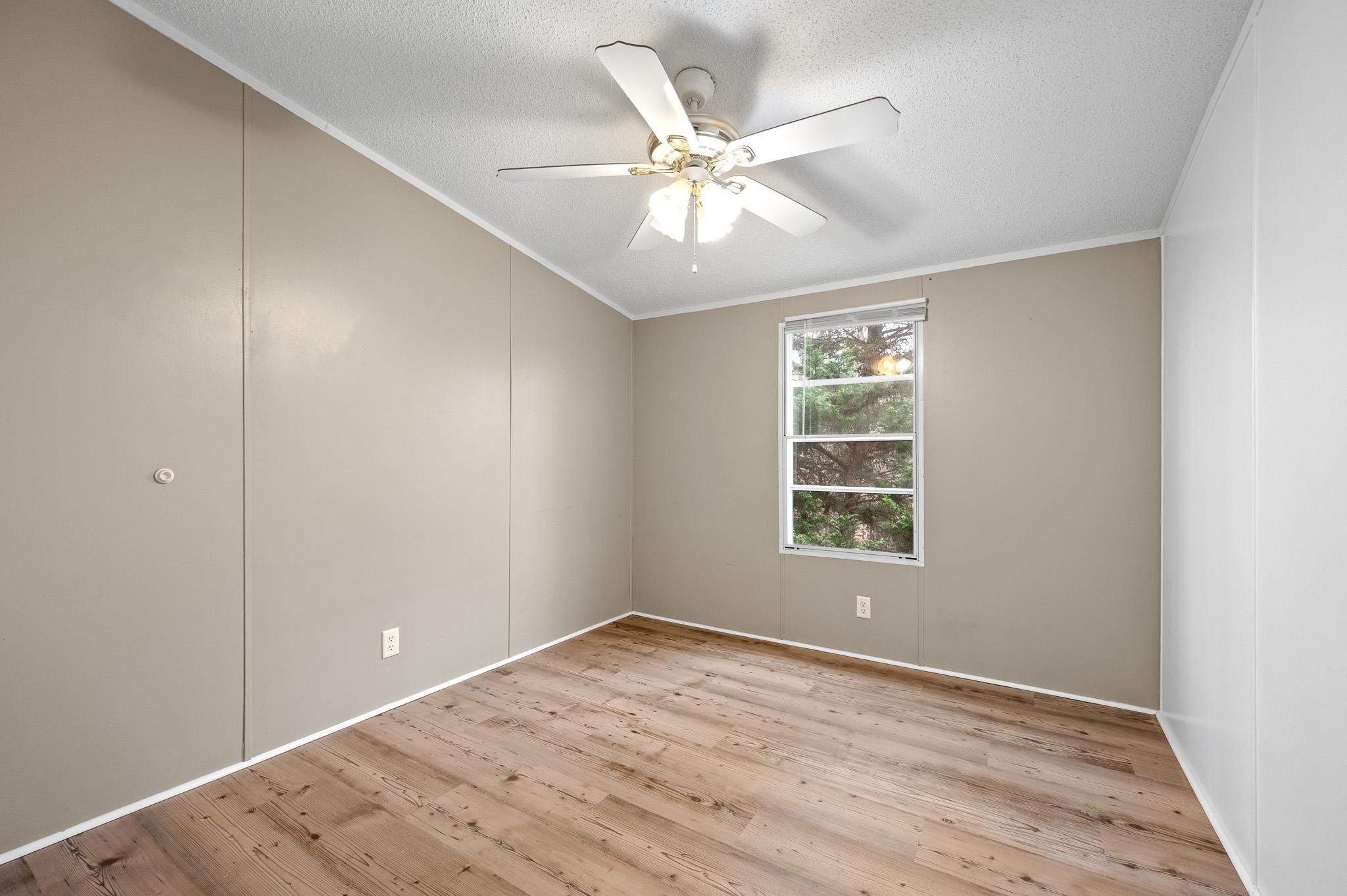 140 Garford Road Madison Heights, VA 24572 - Photo 20 of 32 a view of an empty room with wooden floor and a window