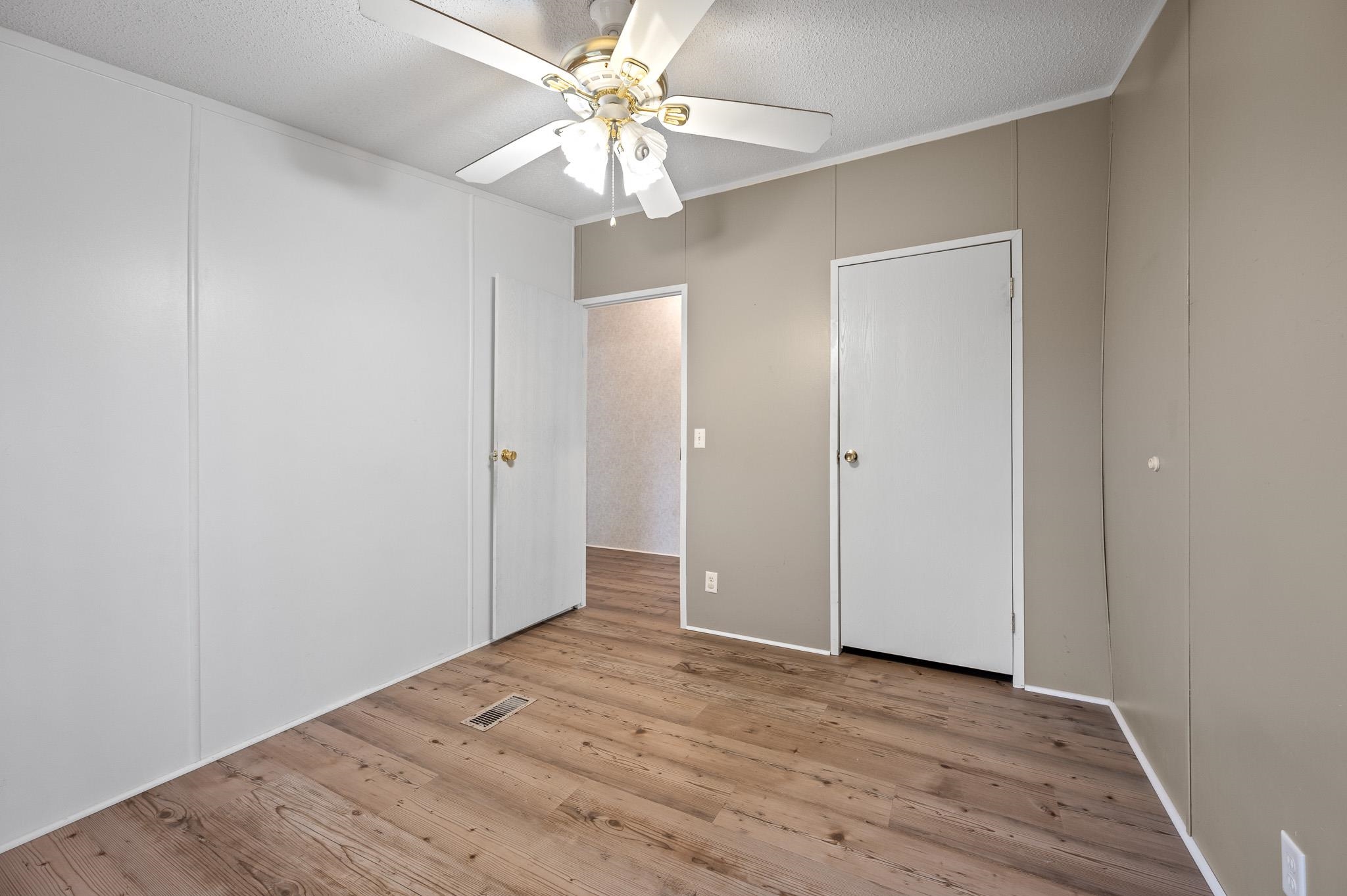 140 Garford Road Madison Heights, VA 24572 - Photo 21 of 32 an empty room with wooden floor and fan