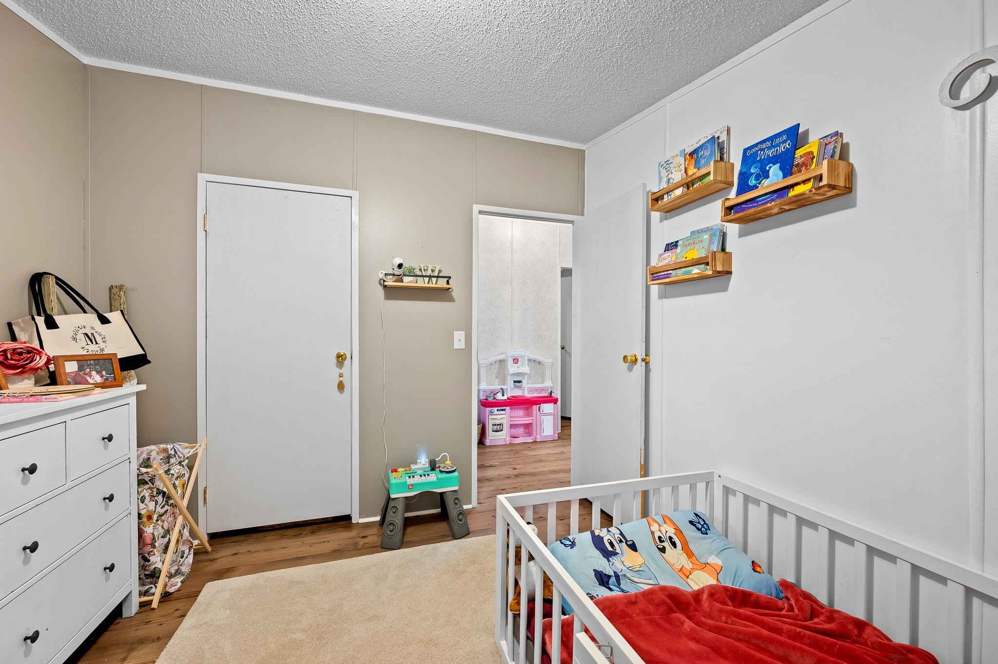 140 Garford Road Madison Heights, VA 24572 - Photo 24 of 35 a bedroom with baby bed toys and paintings on the wall