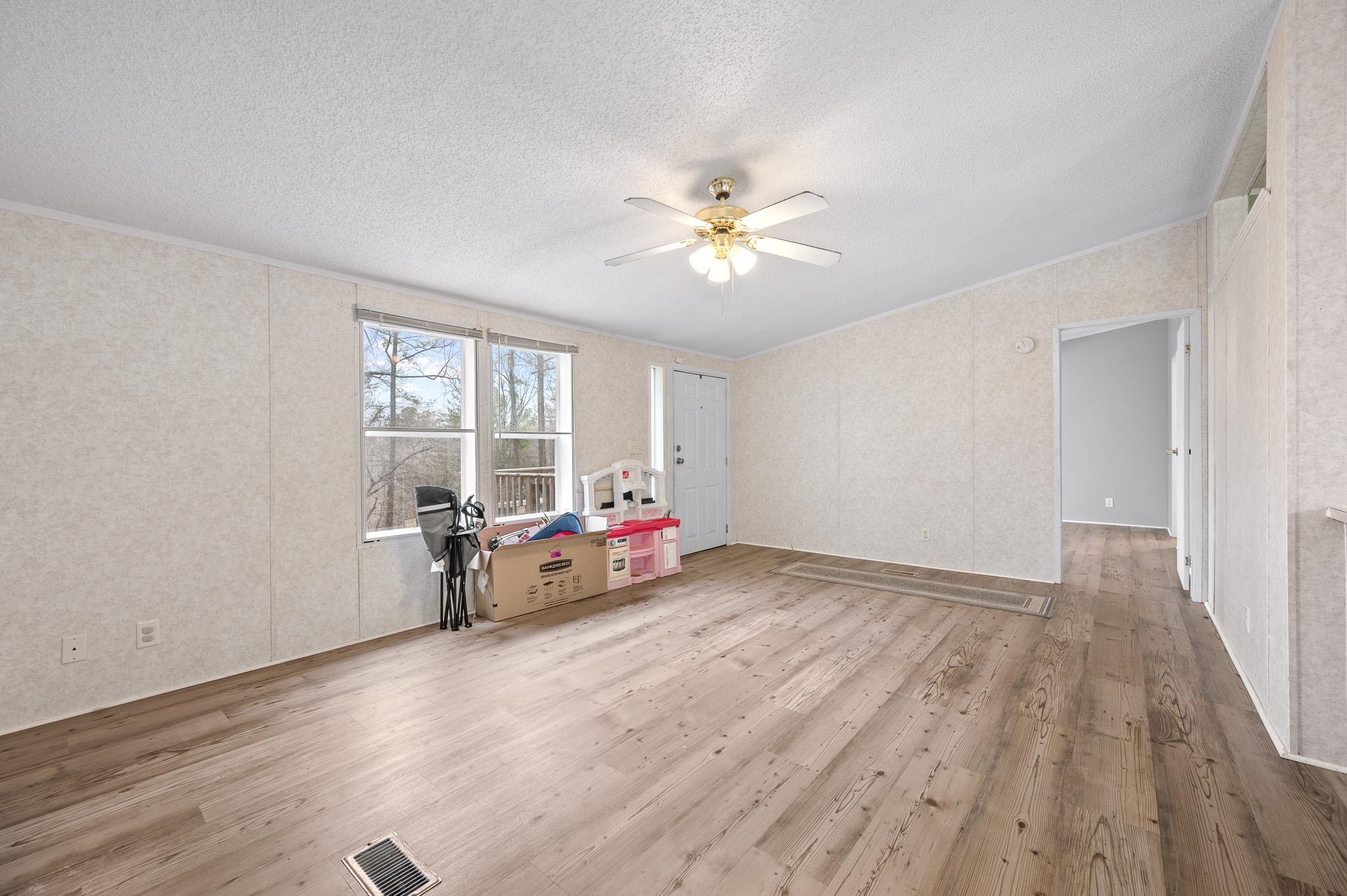 140 Garford Road Madison Heights, VA 24572 - Photo 7 of 32 an empty room with windows and ceiling fan