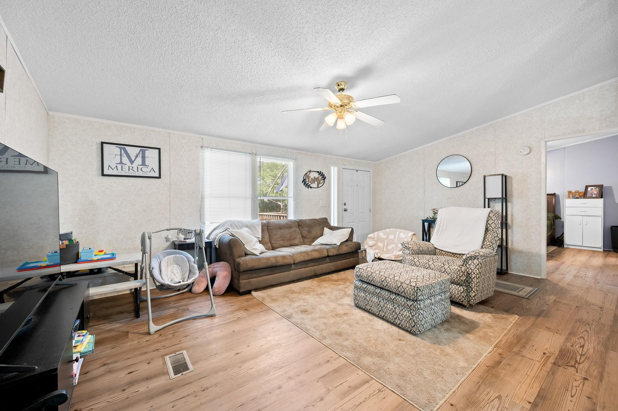 140 Garford Road Madison Heights, VA 24572 - Photo 8 of 35 a living room with furniture a wooden floor and a chandelier