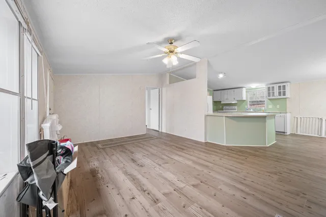 a view of a kitchen with a sink dishwasher and a dishwasher with wooden floor