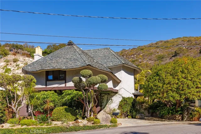 a front view of a house with garden