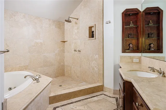 a bathroom with a granite countertop sink a mirror and shower