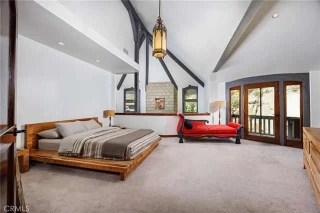 a spacious bedroom with a bed and a large window