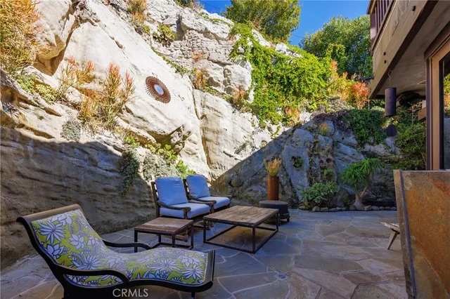 a view of backyard with outdoor seating and trees