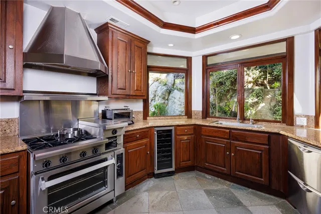 a kitchen with a stove a sink and cabinets