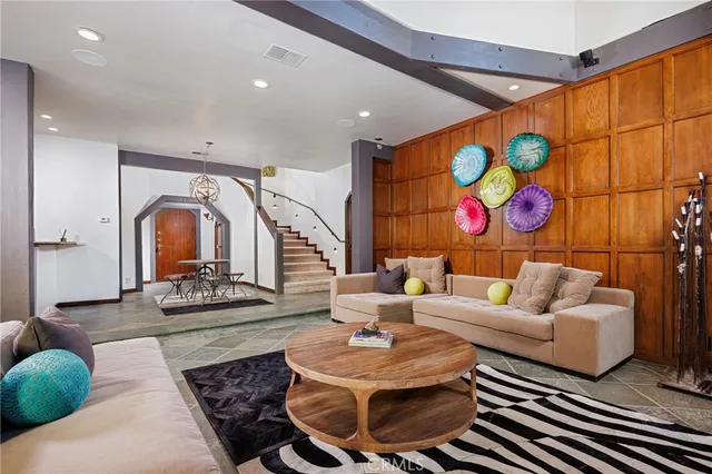 a living room with furniture a rug and white walls