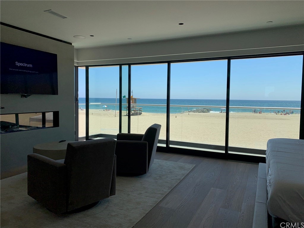 5205 Seashore Drive Newport Beach, CA 92663 - Photo 3 of 10 a living room with couches and a flat screen tv