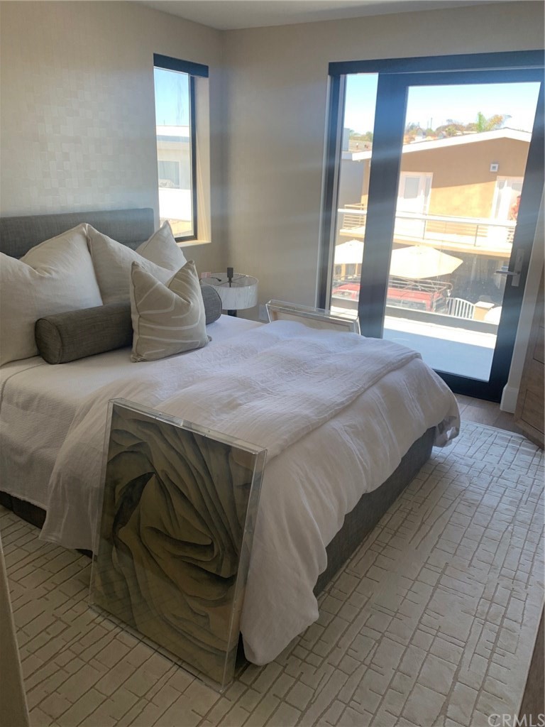 5205 Seashore Drive Newport Beach, CA 92663 - Photo 8 of 10 a bedroom with a bed and window