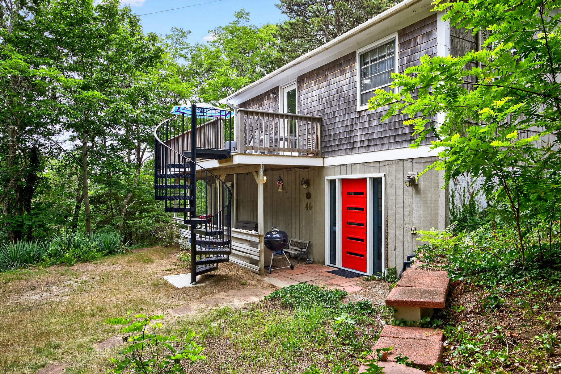 46 Hiram Hill Road Wellfleet, MA 02667 - Photo 24 of 36 a front view of a house with a yard