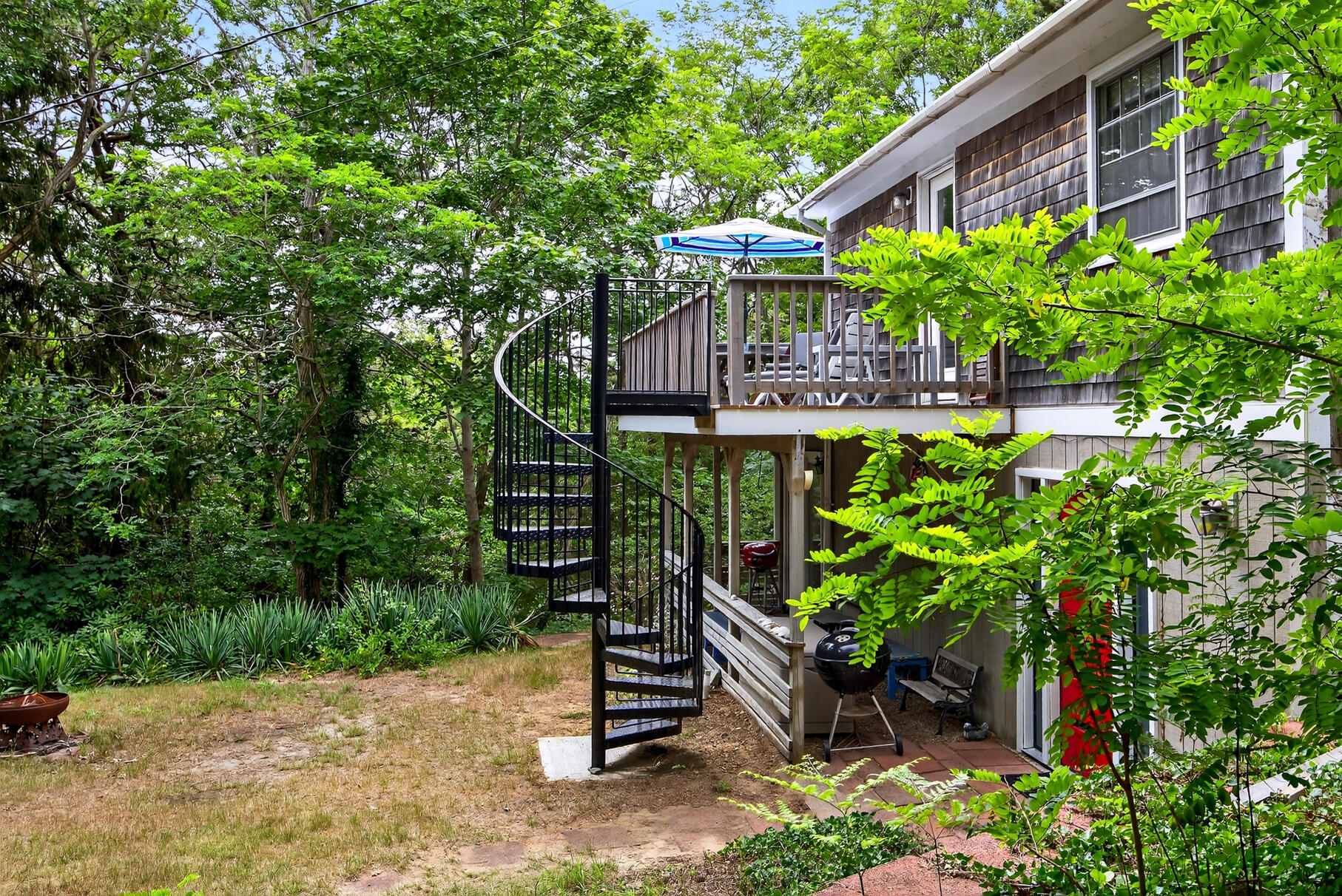 46 Hiram Hill Road Wellfleet, MA 02667 - Photo 28 of 36 a backyard of a house with lots of green space
