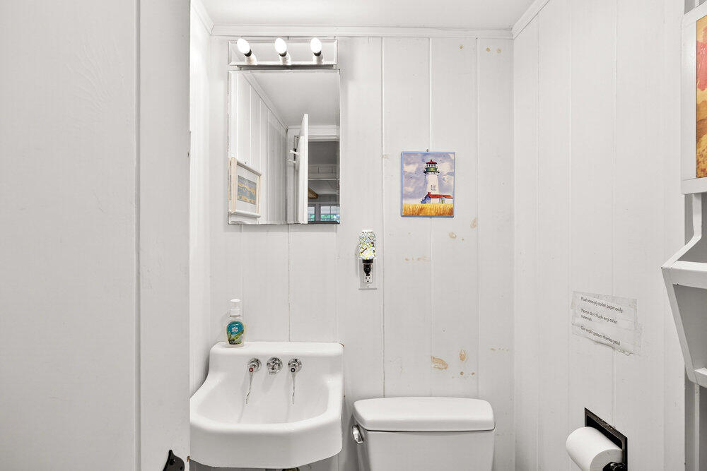 46 Hiram Hill Road Wellfleet, MA 02667 - Photo 34 of 36 a bathroom with a toilet a sink and a mirror