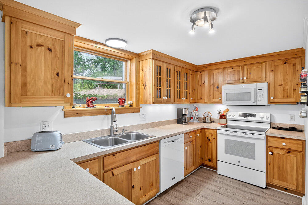 46 Hiram Hill Road Wellfleet, MA 02667 - Photo 8 of 36 a kitchen with cabinets a sink and appliances