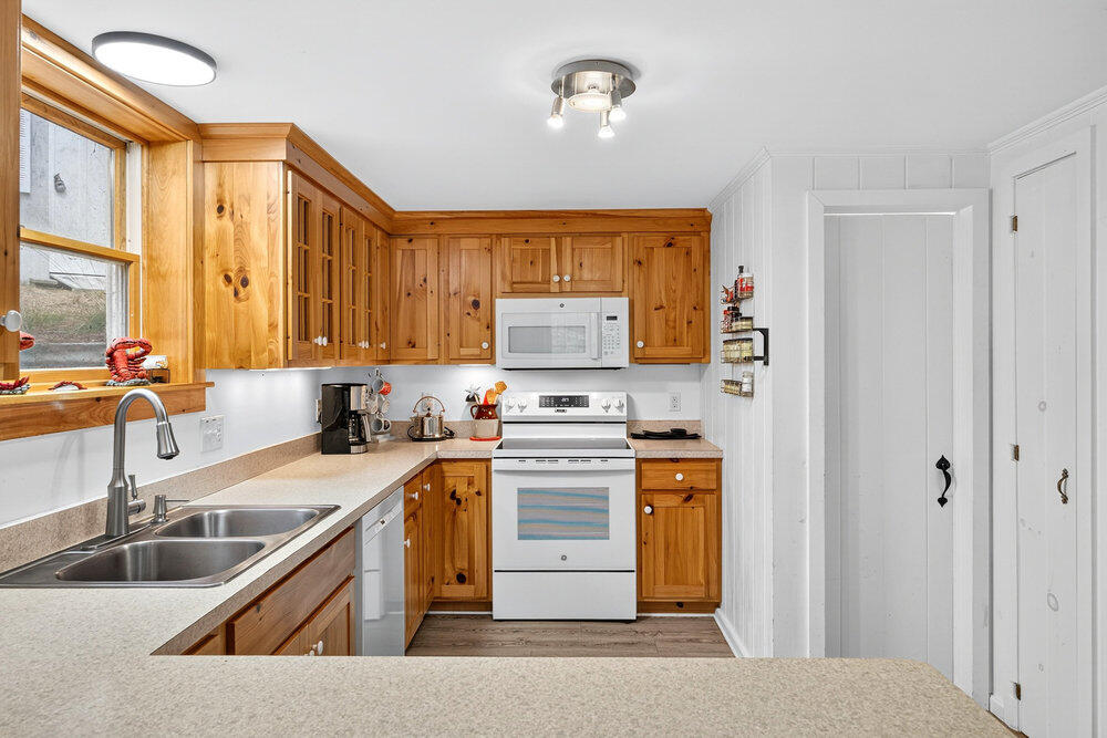 46 Hiram Hill Road Wellfleet, MA 02667 - Photo 10 of 36 a kitchen with stainless steel appliances granite countertop a sink stove and refrigerator