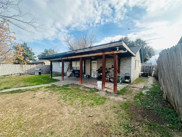 a view of a house with backyard porch and sitting area