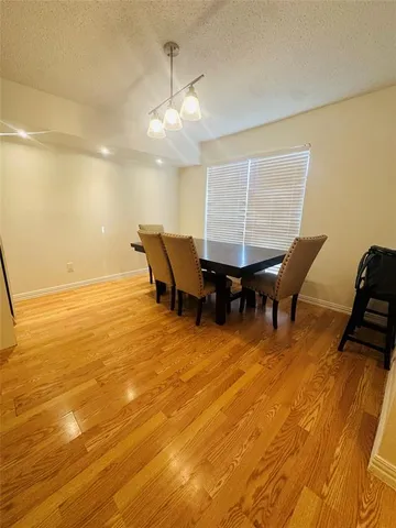 a view of a room with furniture wooden floor and chandelier
