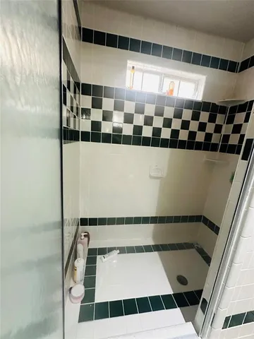 a bathroom with a shower and a mirror
