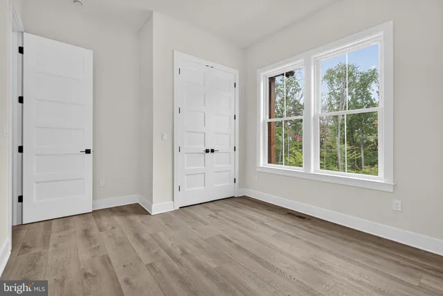 a bedroom with bed and window