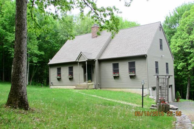 a view of a house with a yard and tree s
