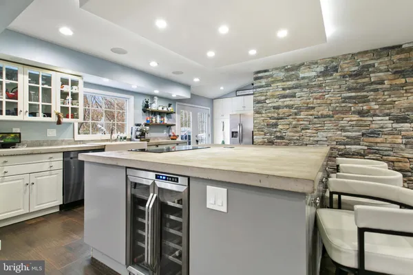 a kitchen with kitchen island a sink stainless steel appliances and window