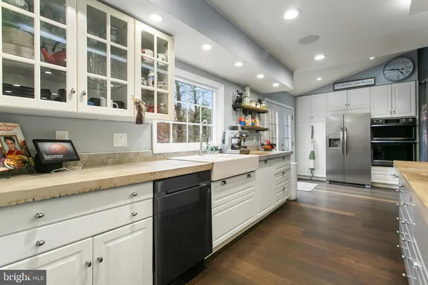 a kitchen with stainless steel appliances granite countertop a sink and cabinets