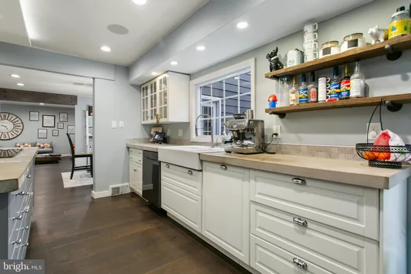 a kitchen with stainless steel appliances granite countertop a sink dishwasher stove and cabinets