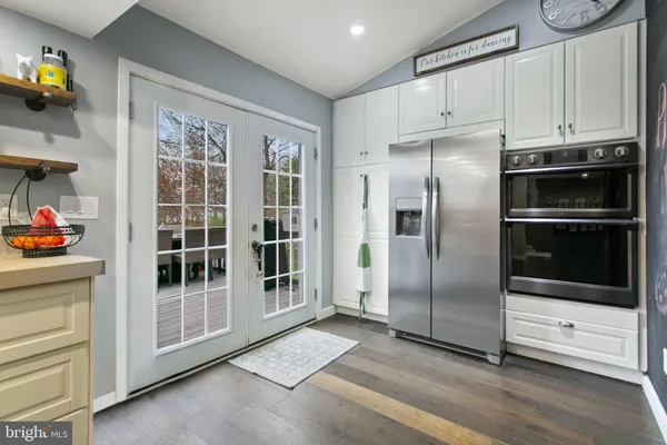 a kitchen with stainless steel appliances a stove a refrigerator and a sink