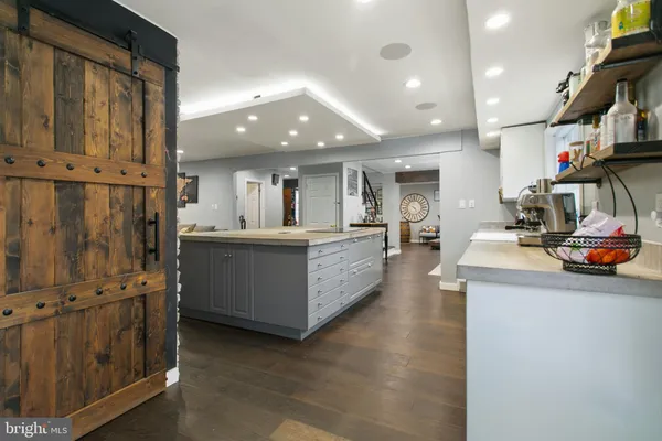 a view of a kitchen with cabinets and wooden floor