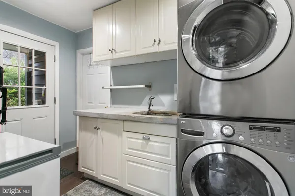 a utility room with sink dryer and washer