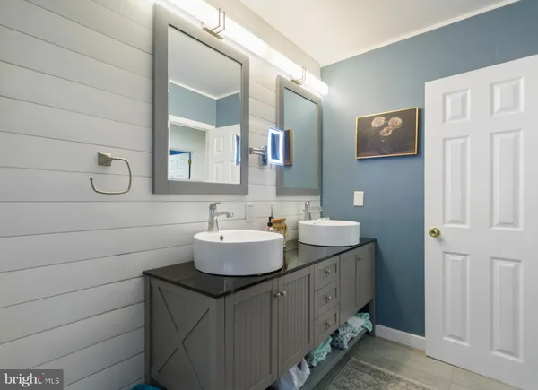 a bathroom with a sink a toilet and shower curtain