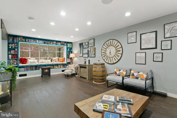 a living room with furniture a window and gym equipment