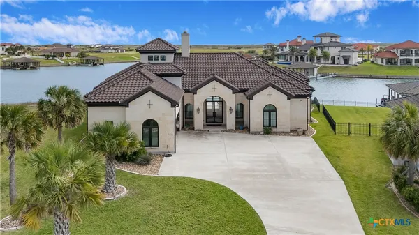 a view of a house with pool and a yard