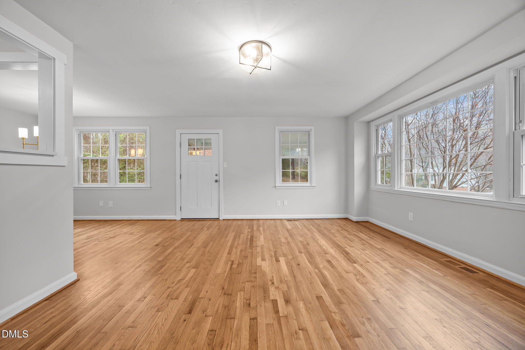 2239 Rumson Road Raleigh, NC 27610 - Photo 12 of 39 a view of an empty room with wooden floor and a window