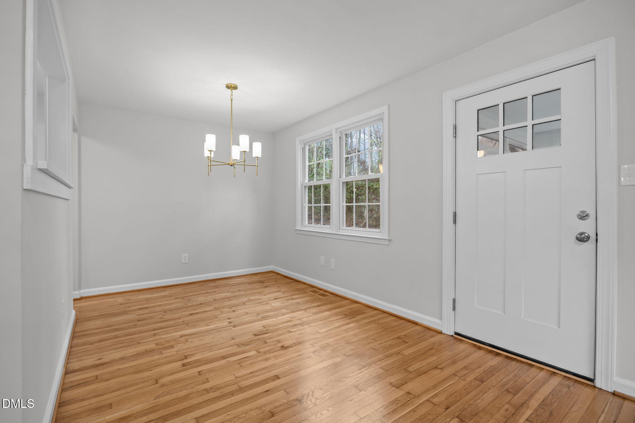 2239 Rumson Road Raleigh, NC 27610 - Photo 14 of 39 a view of an empty room with wooden floor and a window