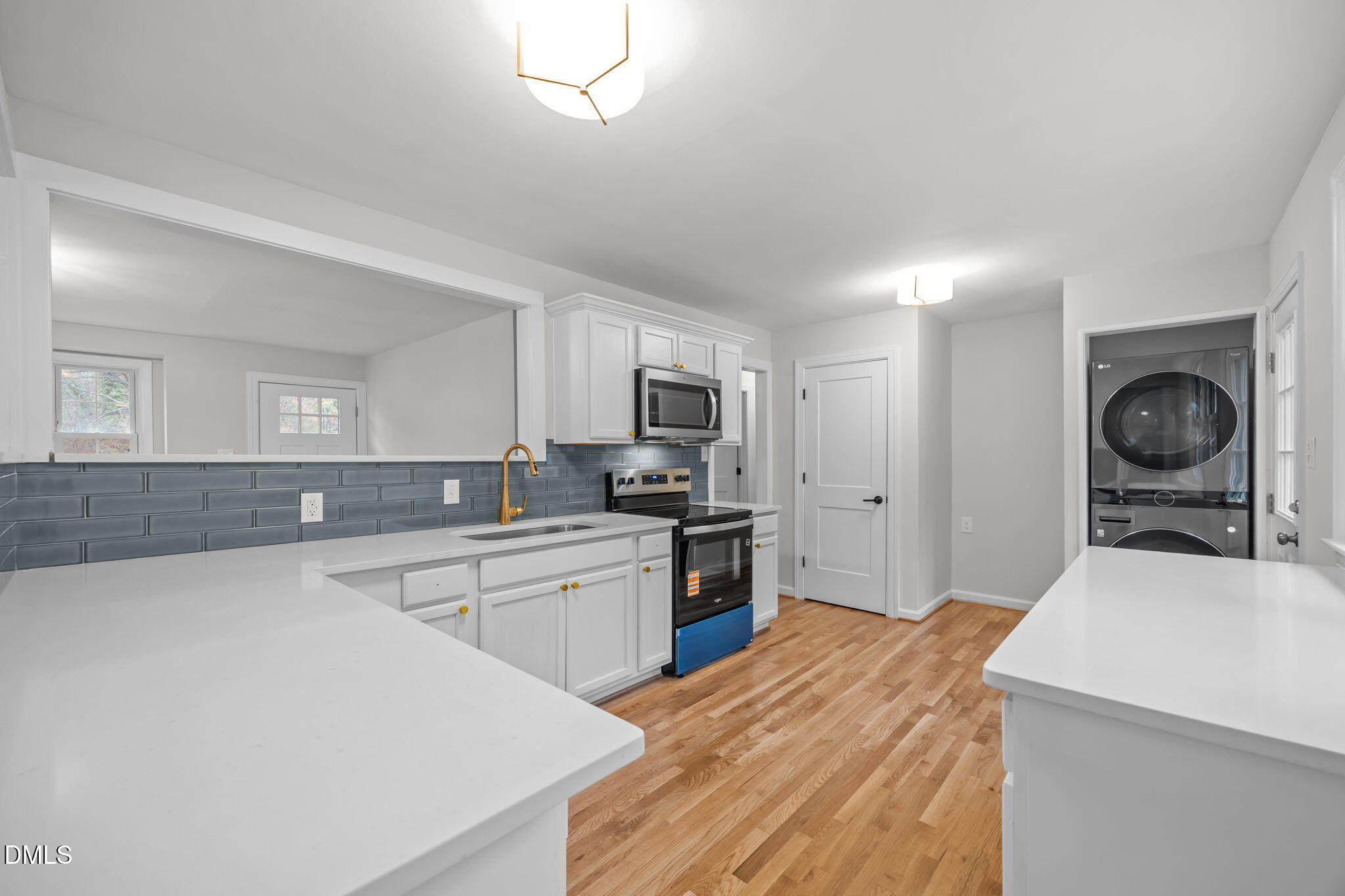 2239 Rumson Road Raleigh, NC 27610 - Photo 17 of 39 a kitchen with granite countertop a sink stove and refrigerator