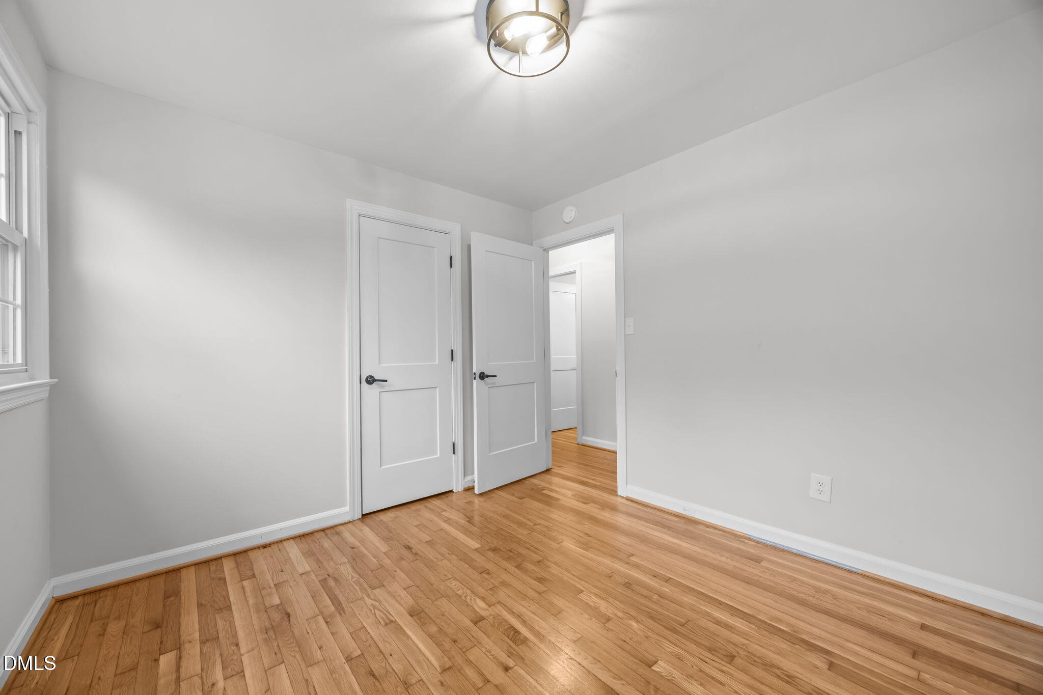 2239 Rumson Road Raleigh, NC 27610 - Photo 26 of 39 a view of an empty room with wooden floor and a window